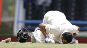 Virat Kohli kisses the turf after completing his maiden double hundred