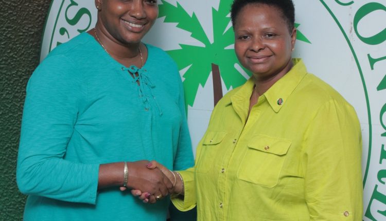 Ms. Lawrence being congratulated by one of the newly elected Vice Chairpersoon of the Party