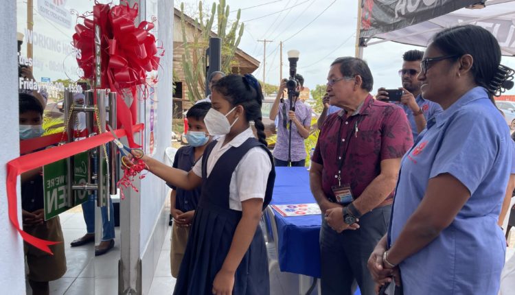 Executive Director (Ag) of the GNBS Ms. Ramrattie Karan and Regional Chairman Mr. Bryan Allicock looks on as pupils of the Arapaima Primary School cuts the ribbon